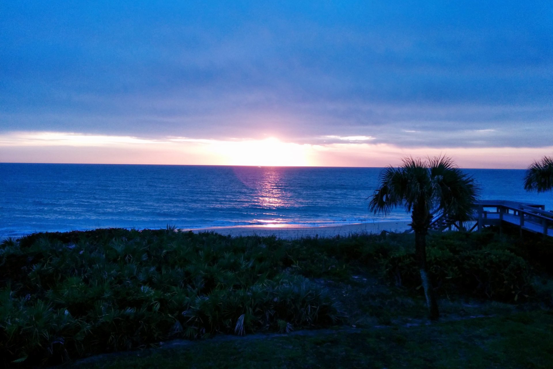 A strange blue hue to the sunrise. Taken from my deck.