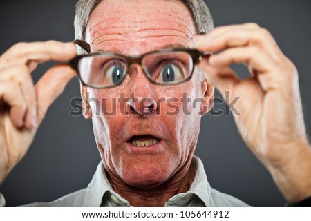 stock-photo-expressive-good-looking-senior-man-against-grey-wall-funny-and-characteristic-big-eyes-well-105644912.jpg
