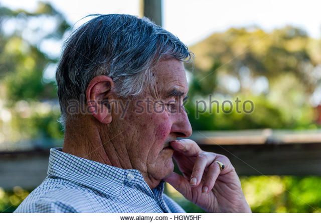 an-elderly-man-rests-on-a-shady-balcony-